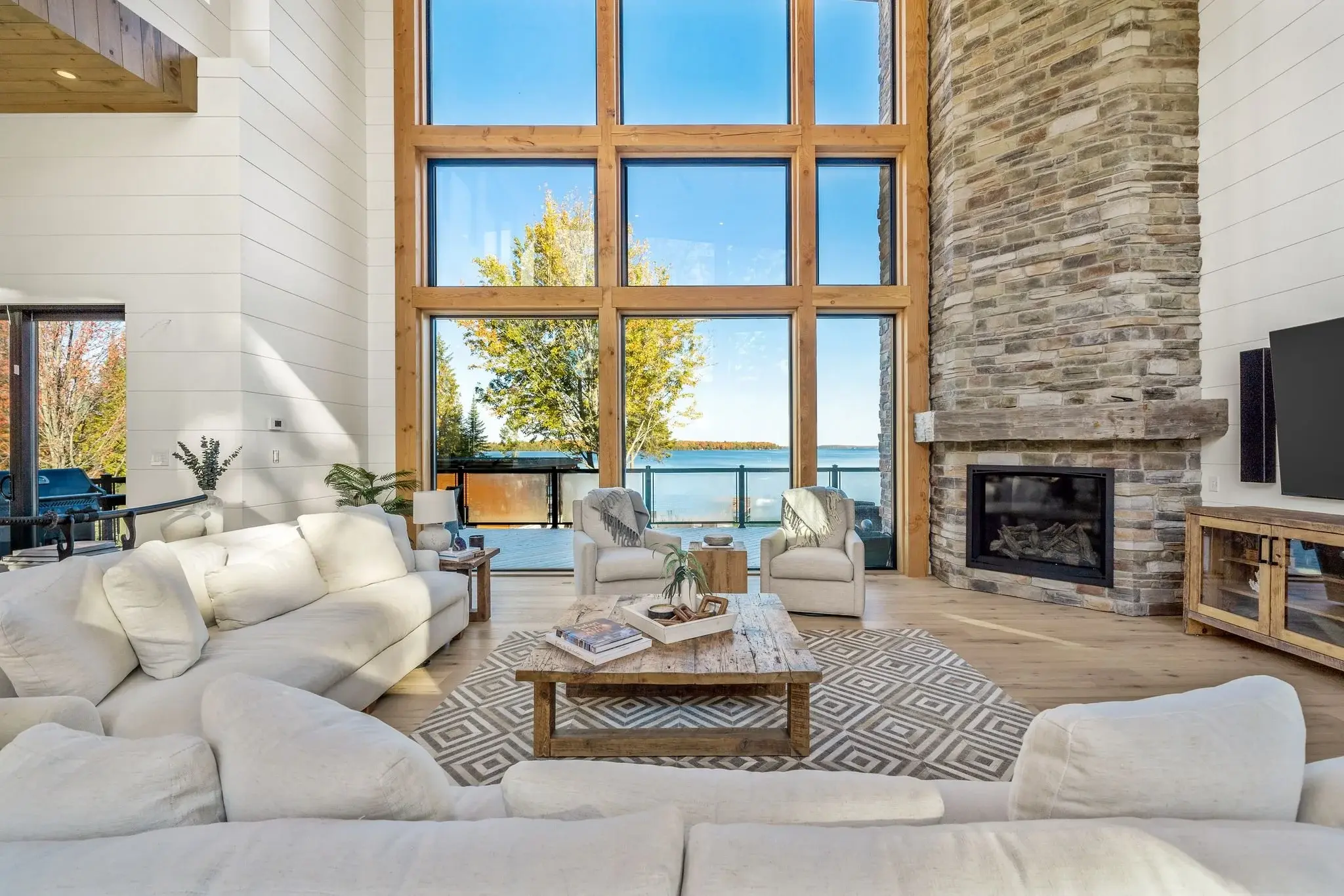 The View on Balsam: living room with stacked-stone fireplace and lake views