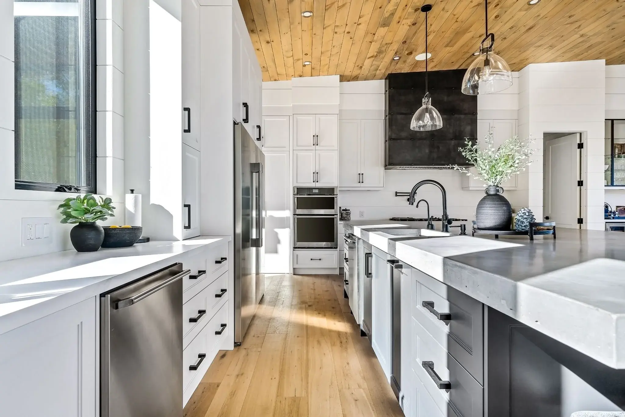 The View on Balsam: galley view of the island with farmhouse sink and black hardware