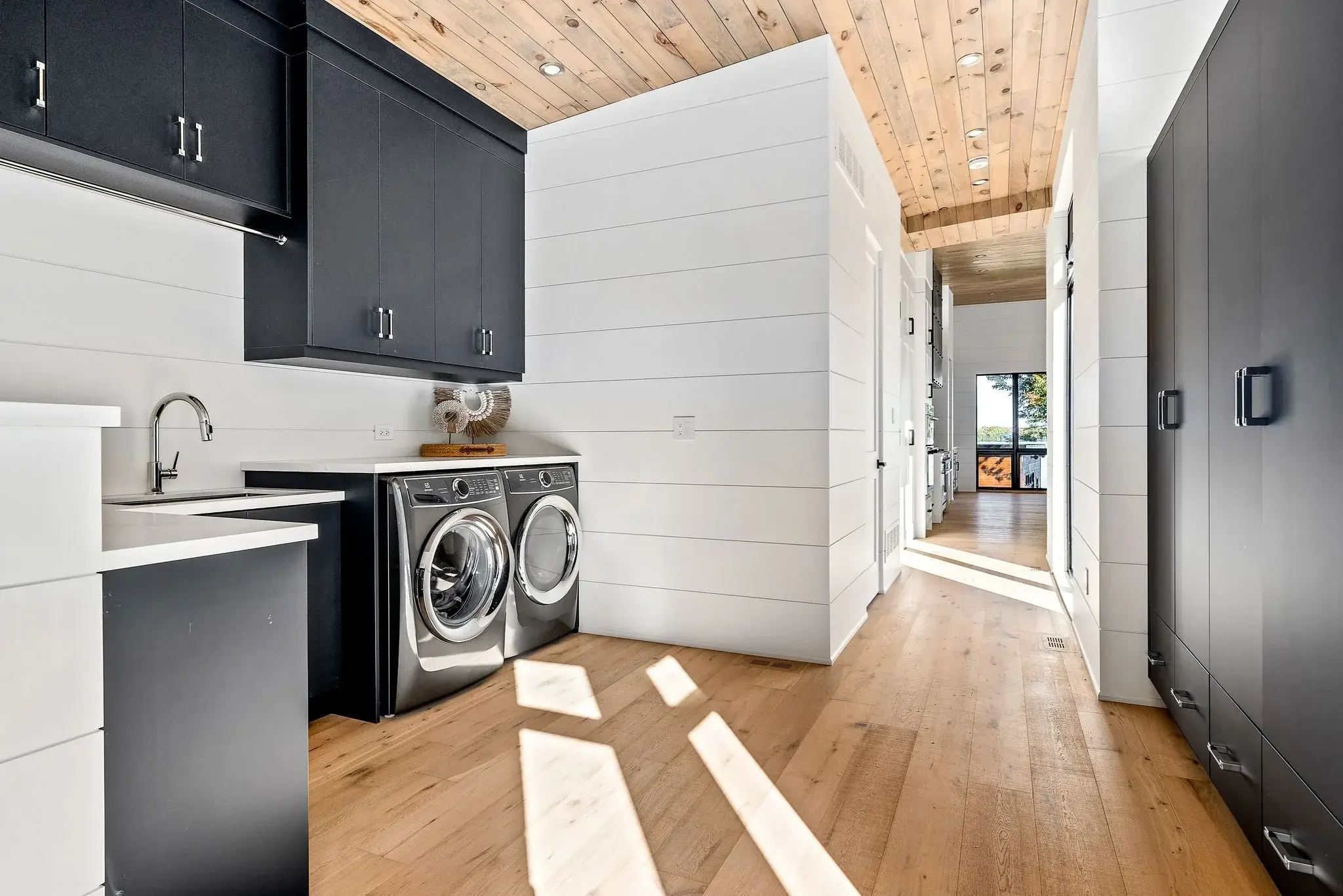 The View on Balsam: laundry room with black cabinetry